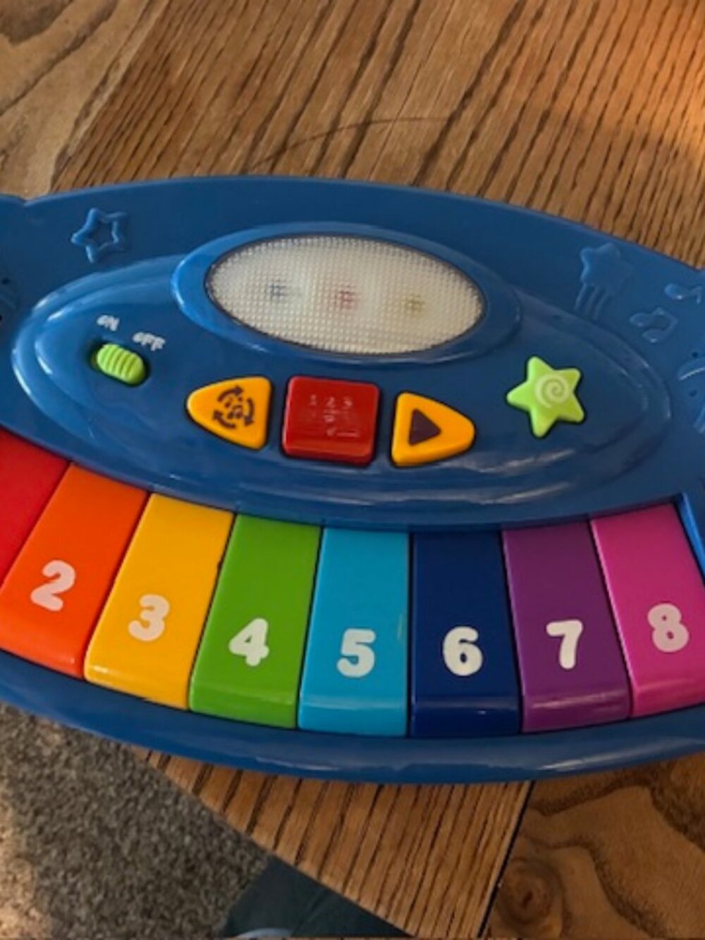 Toddler musical keyboard with red microphone attached